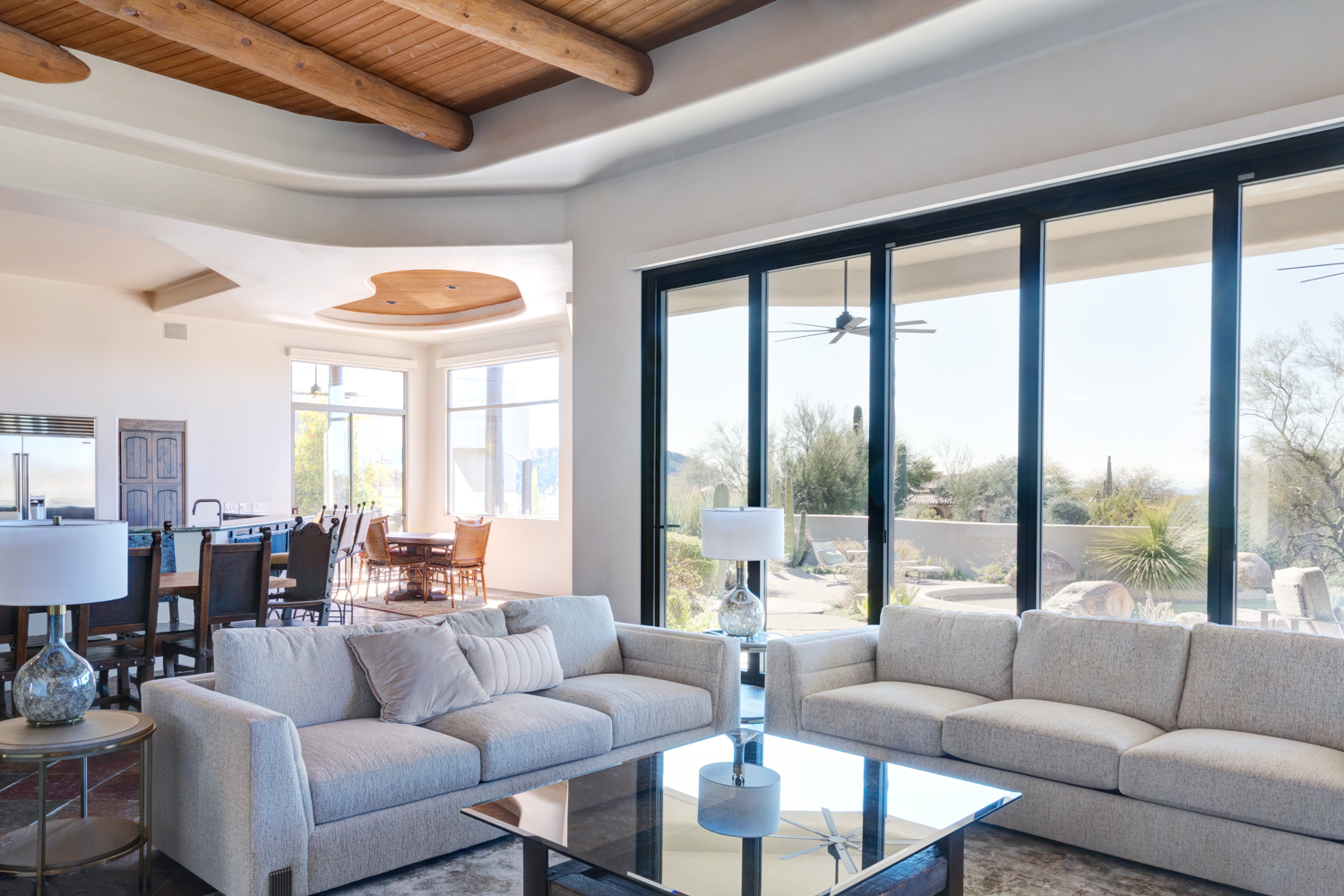 Indoor-outdoor living renovation with large glass sliders and desert landscaping