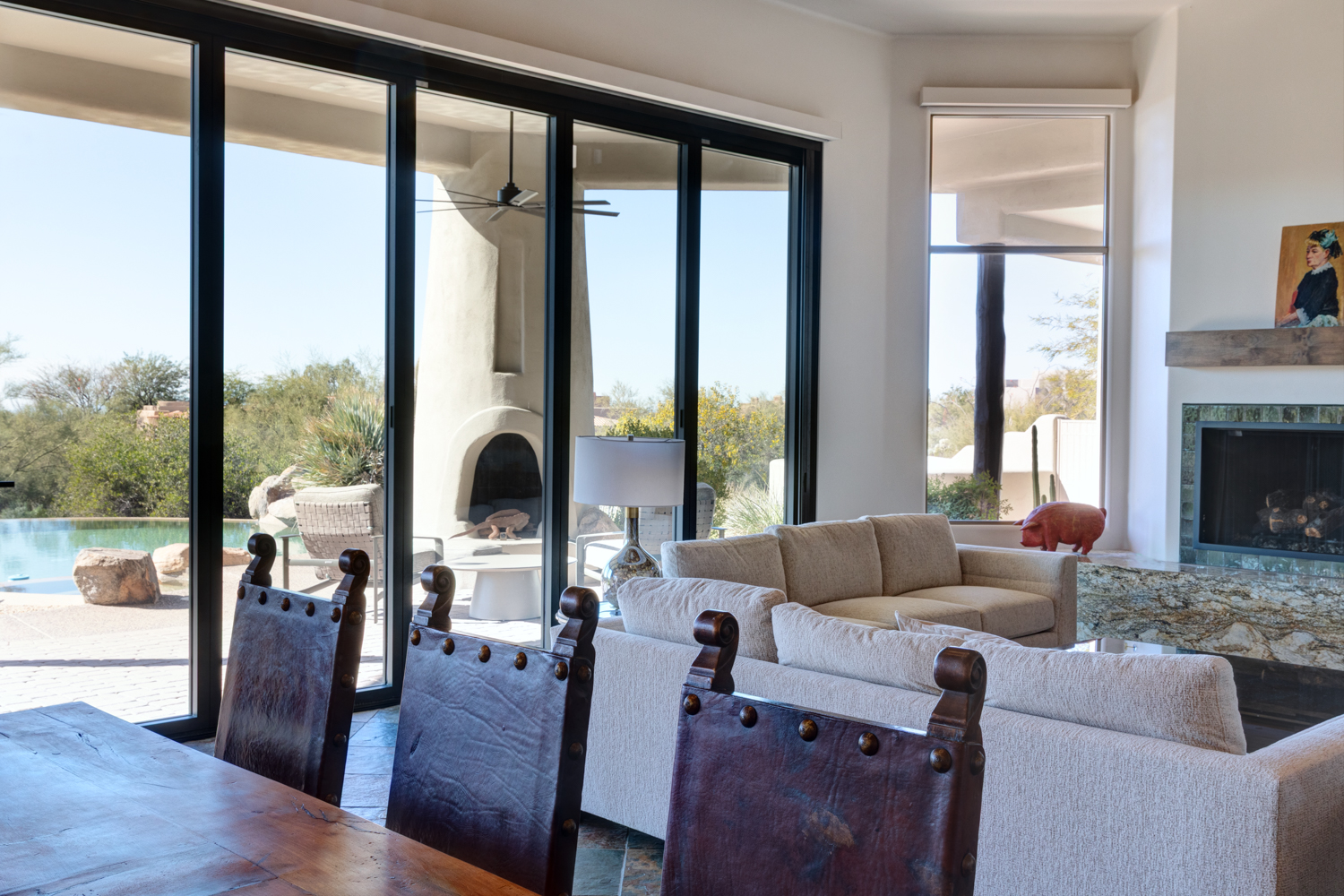Indoor-outdoor living renovation with large glass sliders and desert landscaping