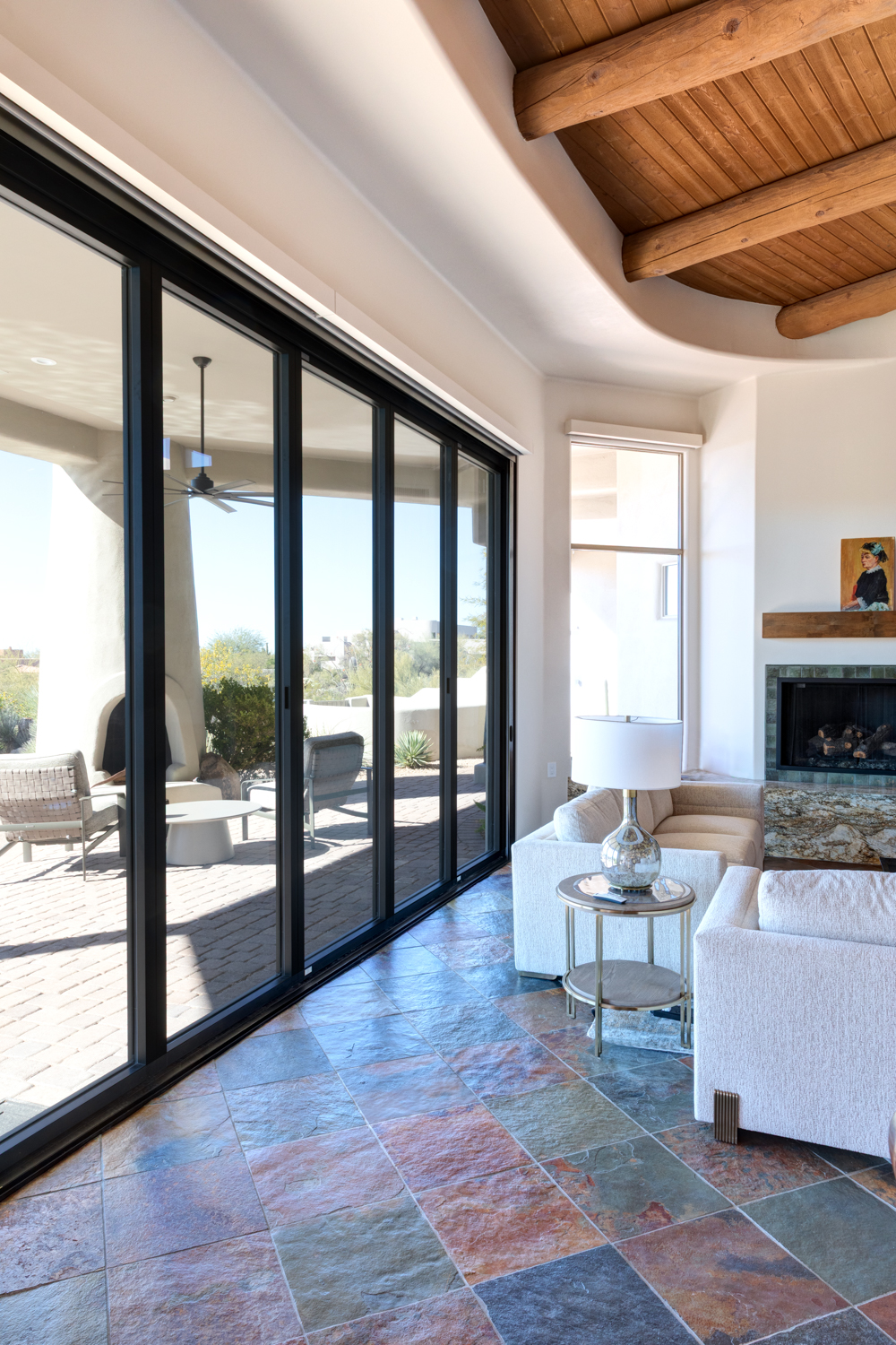 Indoor-outdoor living renovation with large glass sliders and desert landscaping