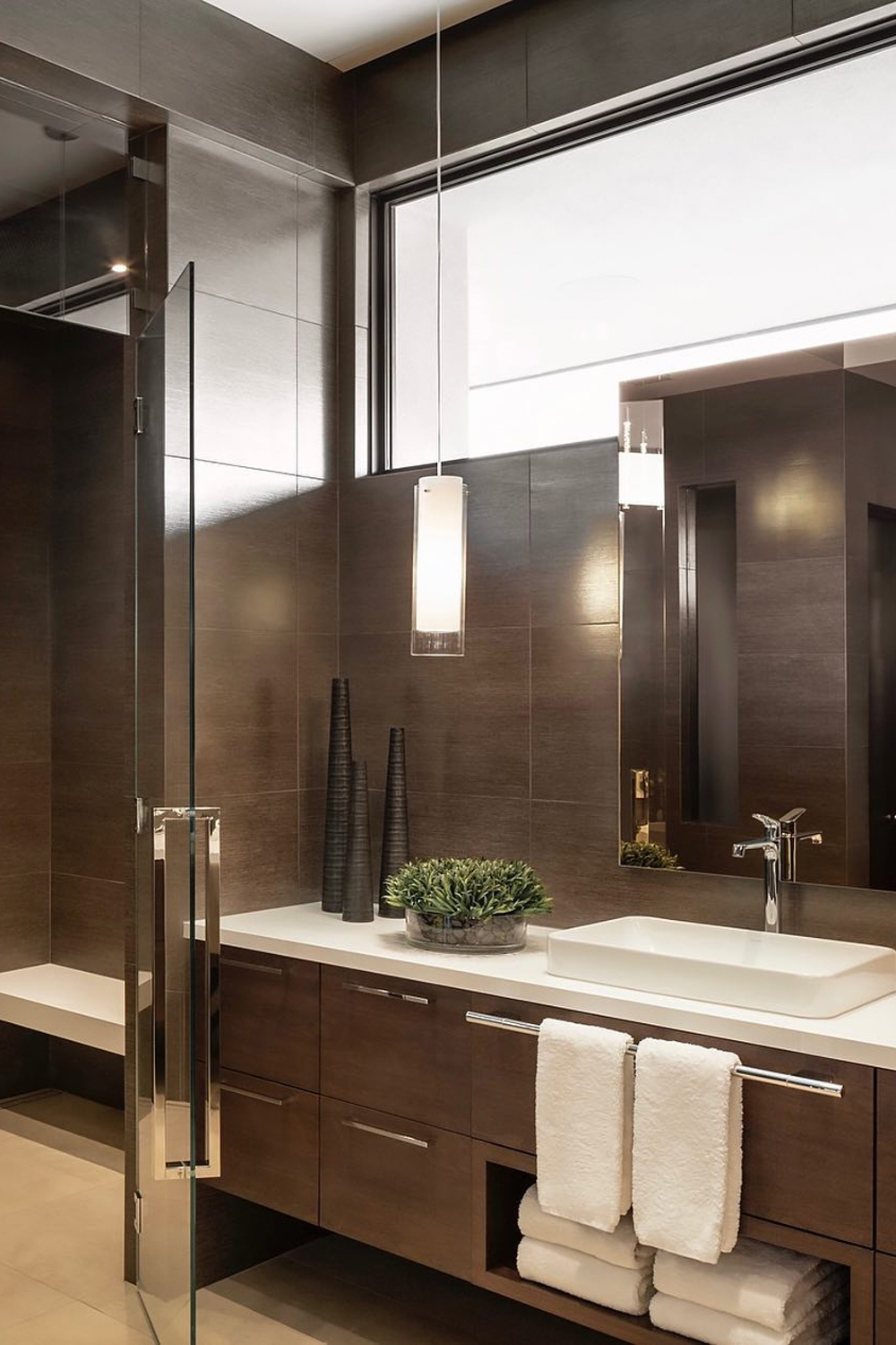 Modern dark wood bathroom vanity with glass shower enclosure Arizona