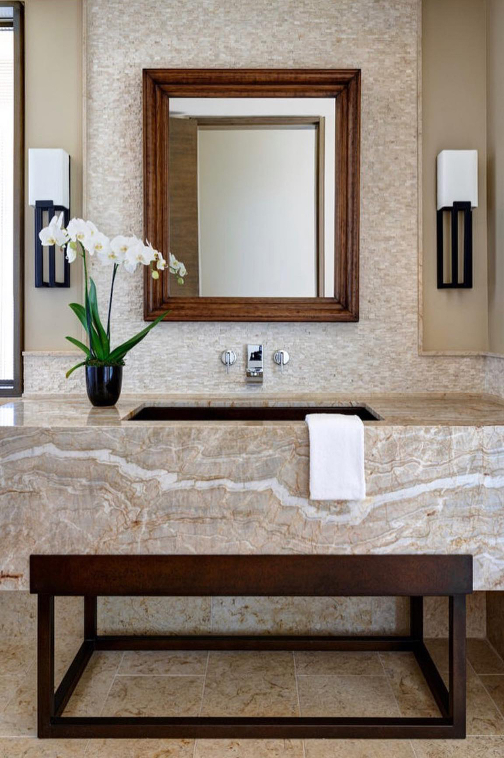 Stone slab vanity with framed mirror in Arizona custom bathroom