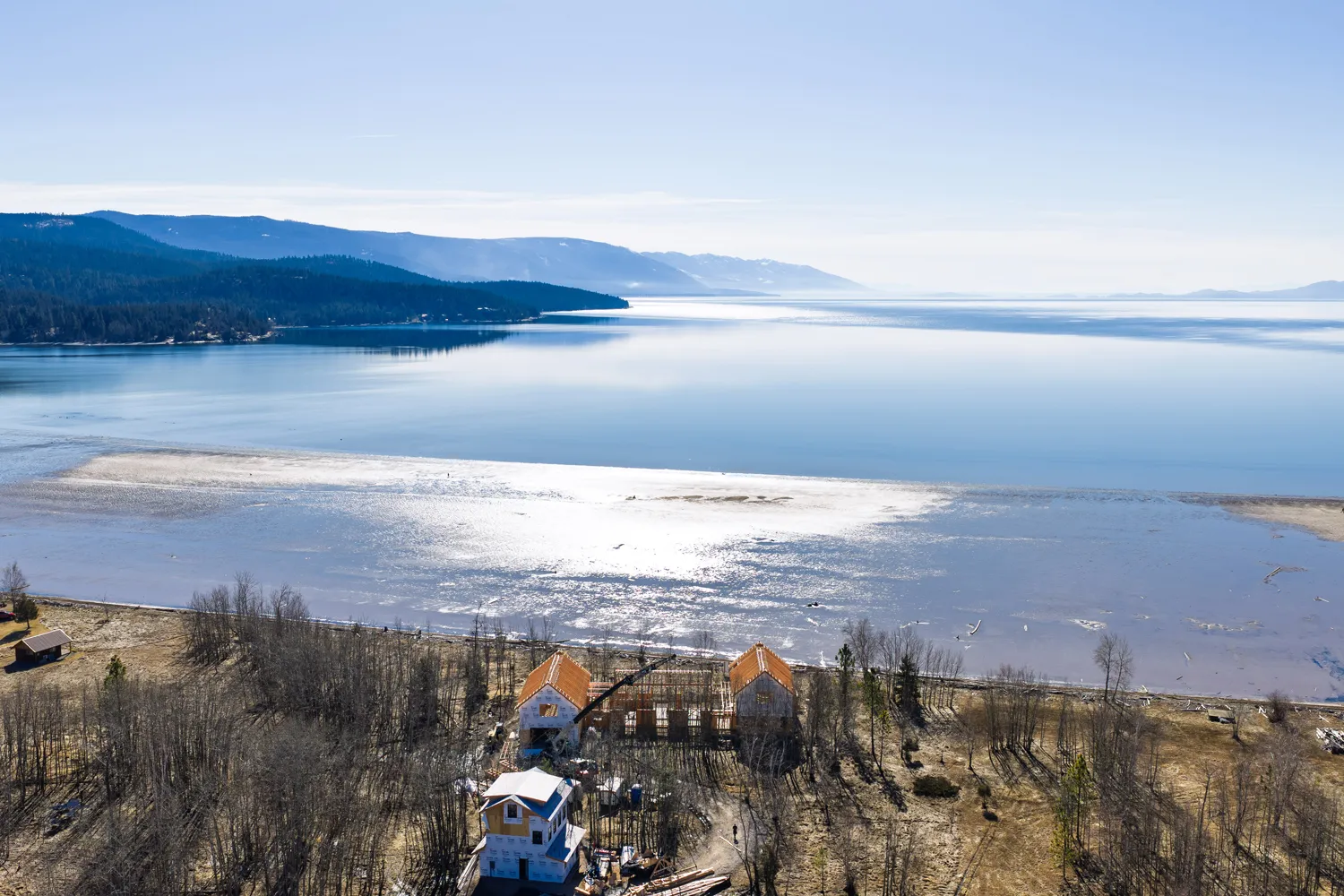 Aerial view of luxury custom home construction on Flathead Lake Montana