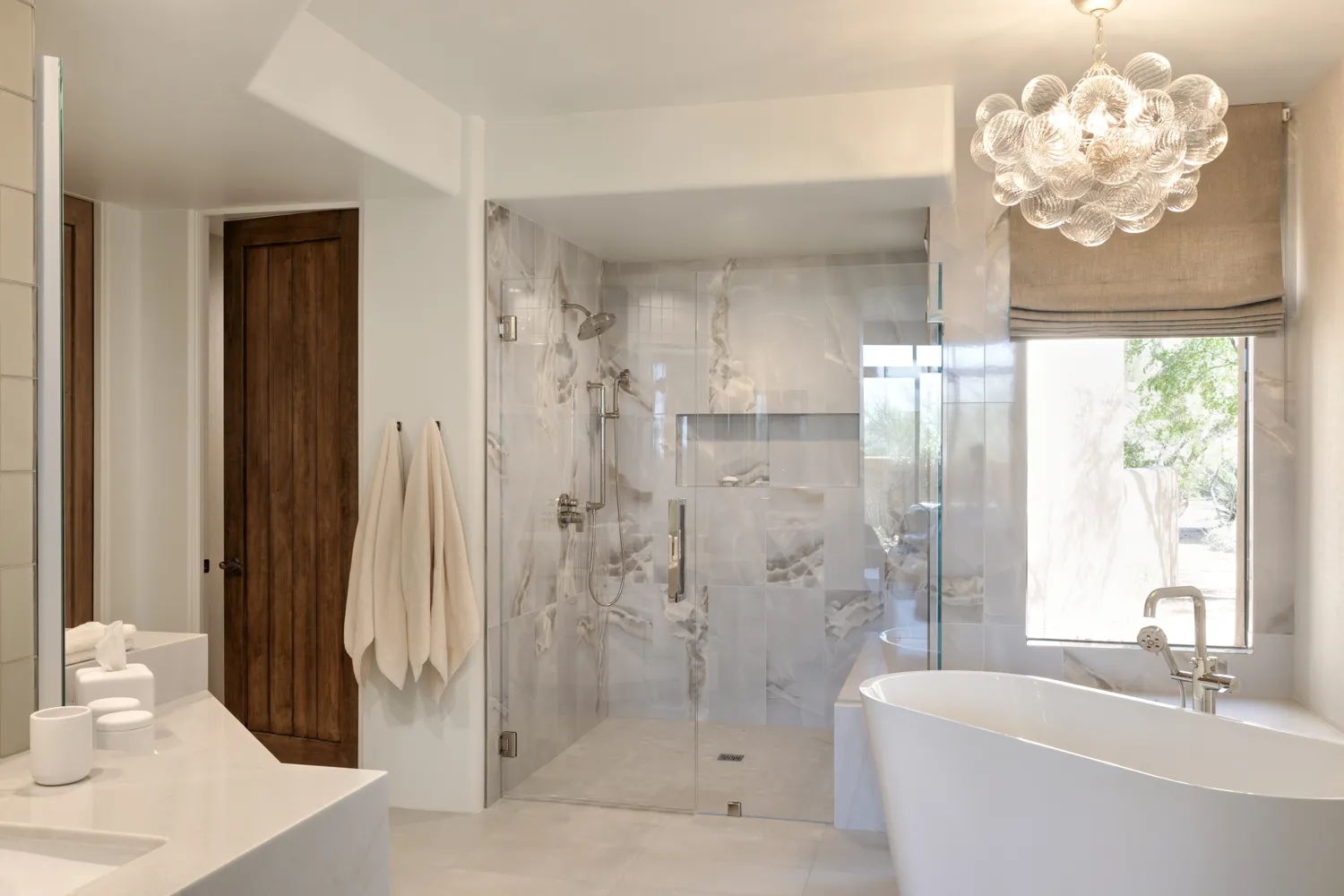 Luxury Scottsdale primary bathroom renovation featuring marble walk-in shower and freestanding soaking tub