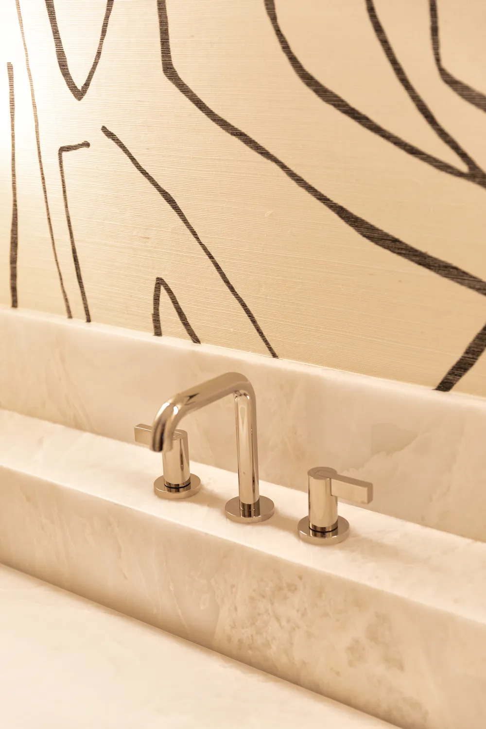 Close-up of brushed nickel faucet on custom marble vanity in Scottsdale luxury remodel